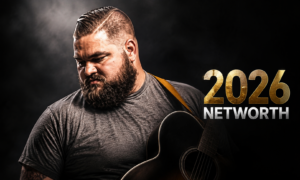 Jake Marlin performing on stage with an acoustic guitar, highlighting his 2026 music career and estimated net worth.